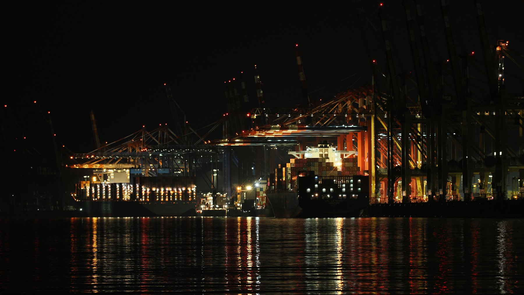Port cranes illuminated at night