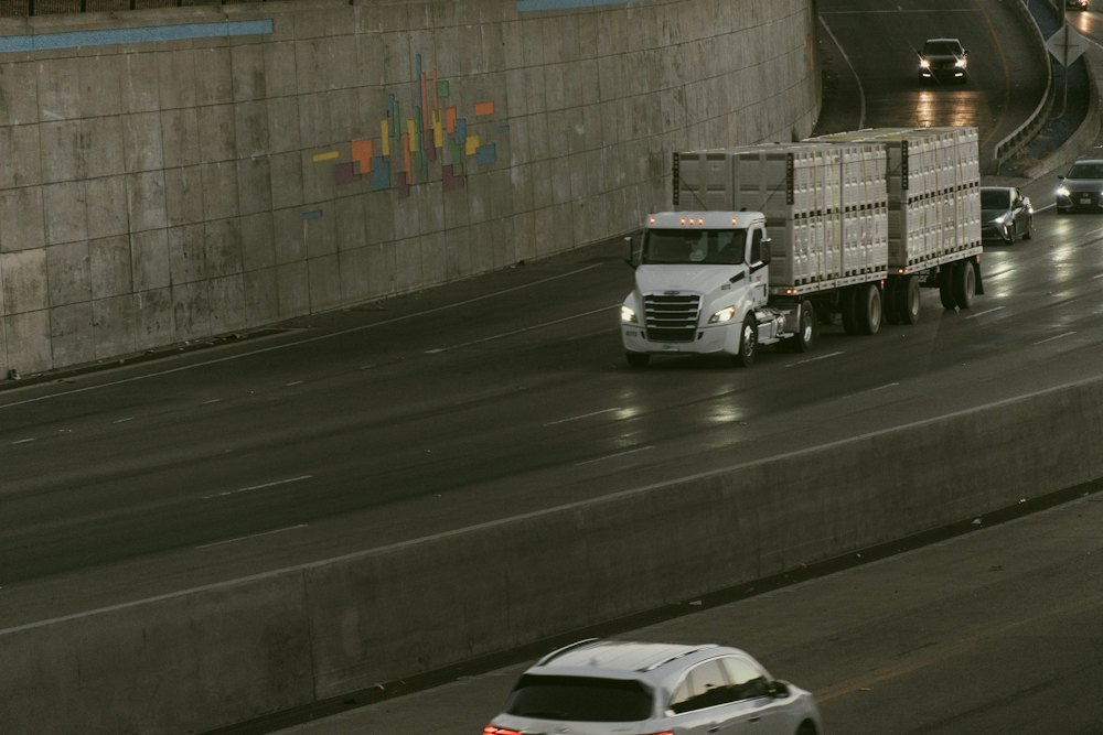 Semi-truck carrying containers along a highway